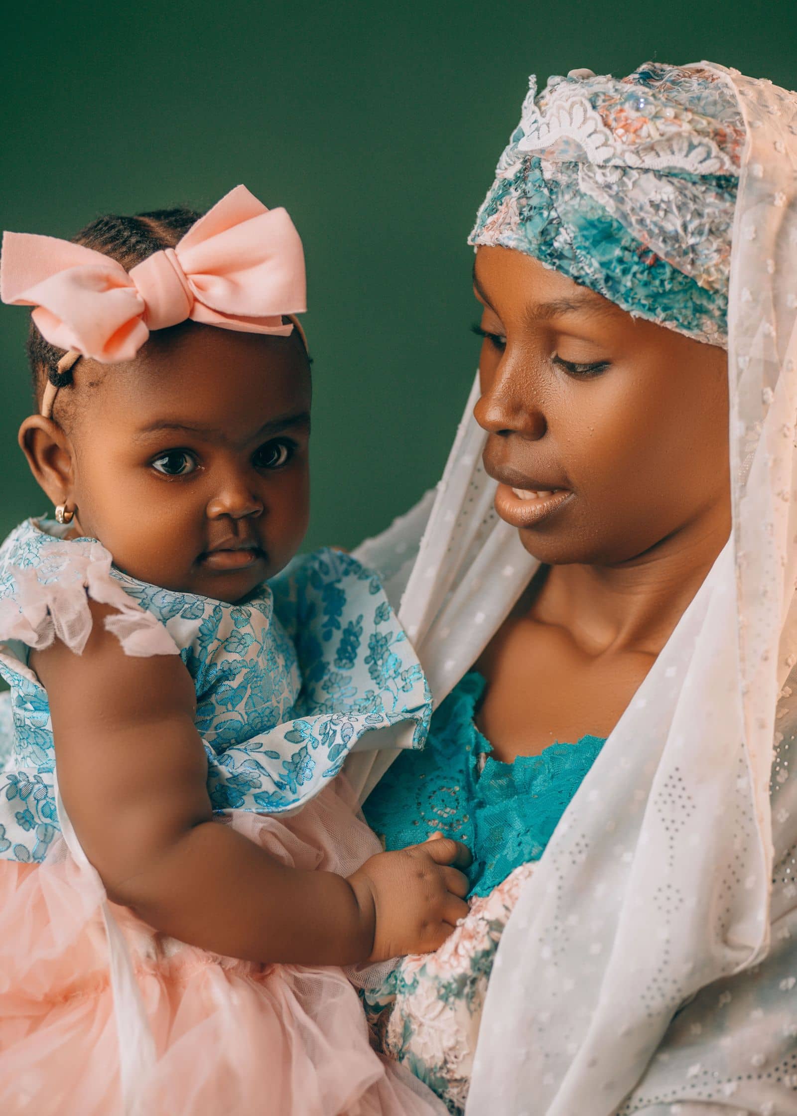 Mother in a lace veil holding her baby daughter